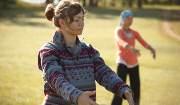 Two women are practicing Qi Gong