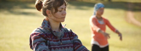 Two women are practicing Qi Gong